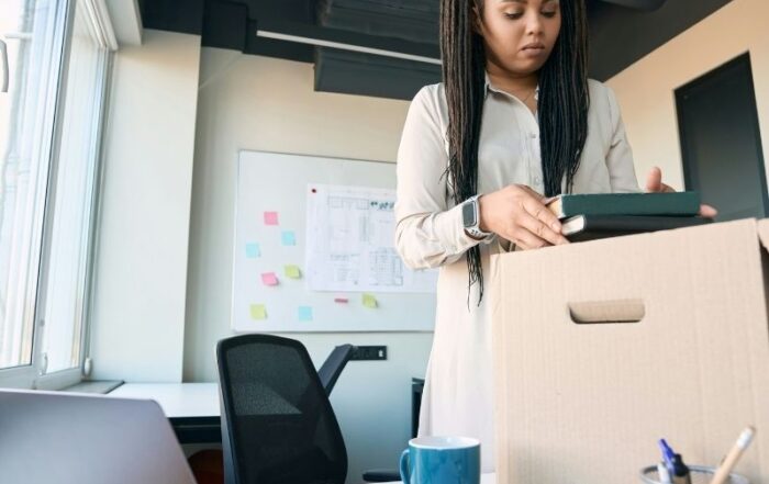 Employee packing a box at her desk