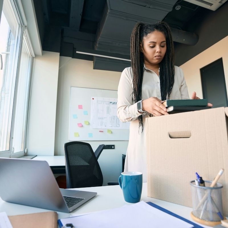Employee packing a box at her desk